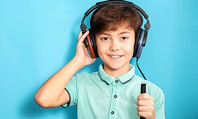 Junge mit Kopfhörer eines Hörtest 